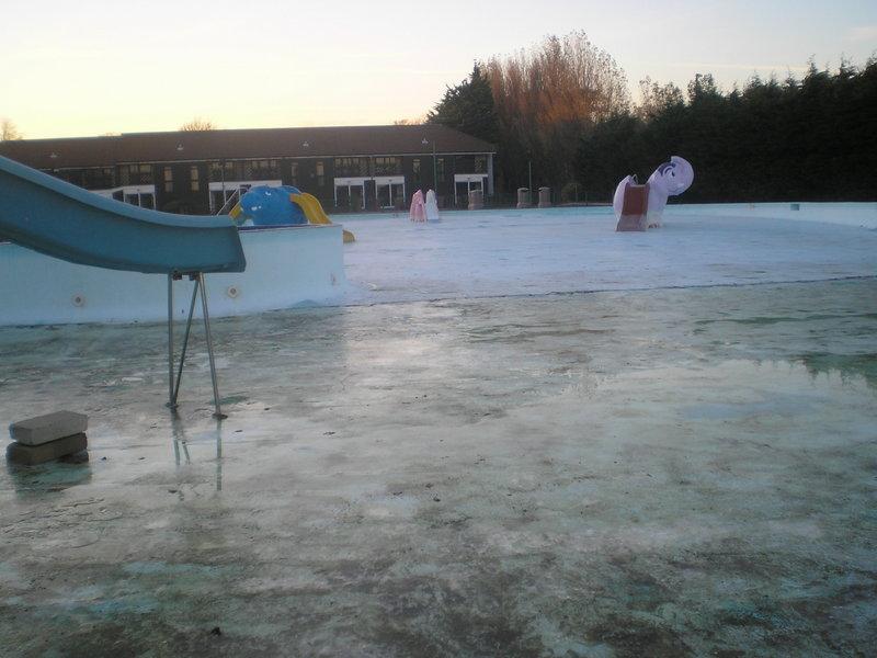 The middle of the pool with the Deluxe chalets in the background