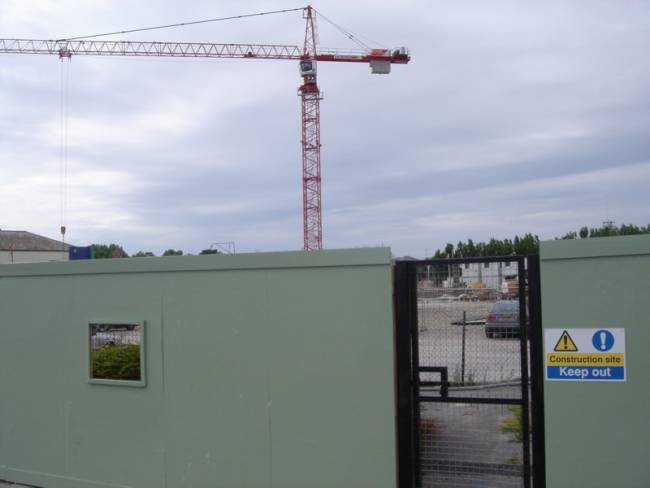 Looking at the fence surrounding the new hotel building site