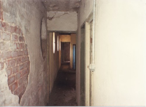 View from top of stairs looking down past projection room