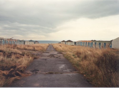 The road to the beach with White Camp on either side and the sea in the distance