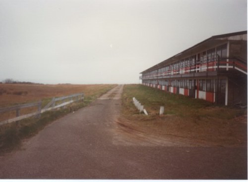 The road leading down to the beach with Blue Camp on the right and the sports field on the left